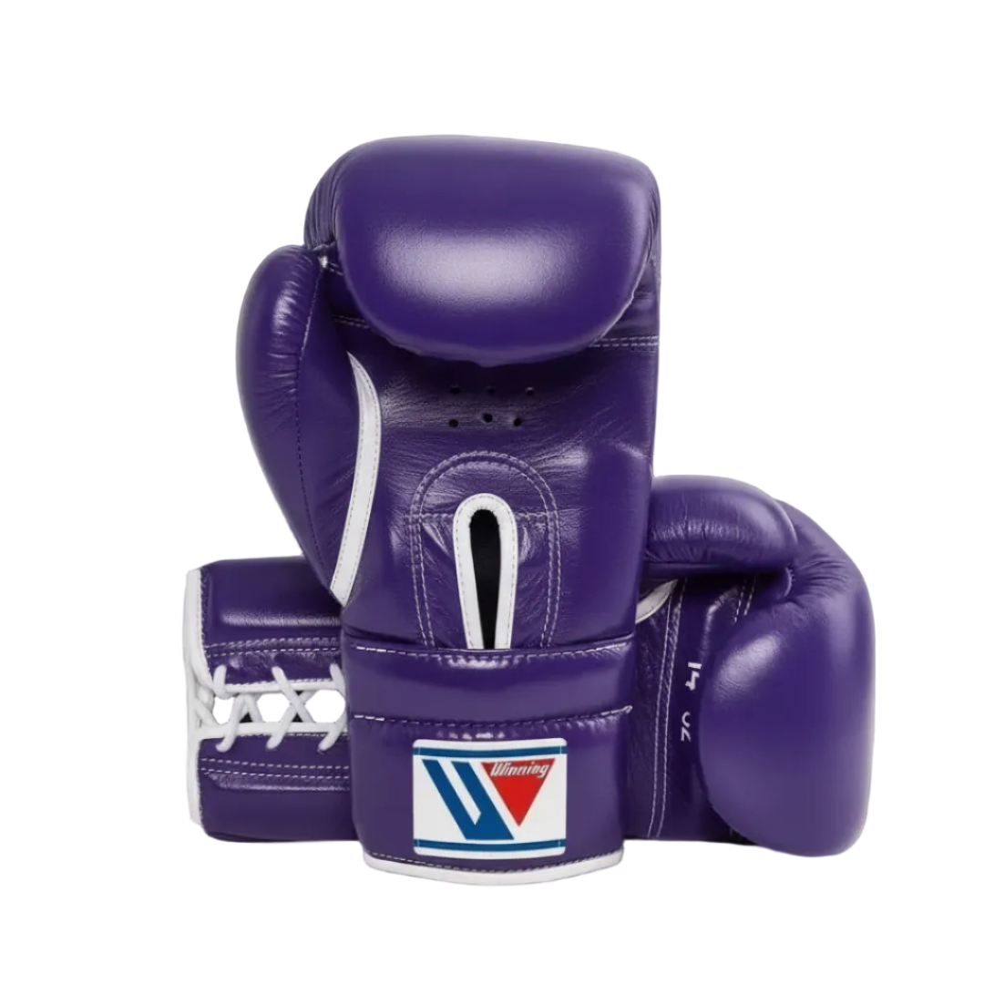 A pair of purple boxing gloves with white laces and white trim, featuring a visible 'Winning' brand patch on the wrist strap, set against a dark navy background.