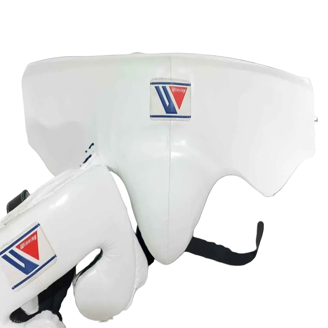 White martial arts headgear and matching gloves with a visible Tri-Star logo patch, shown against a dark blue-to-black gradient background.