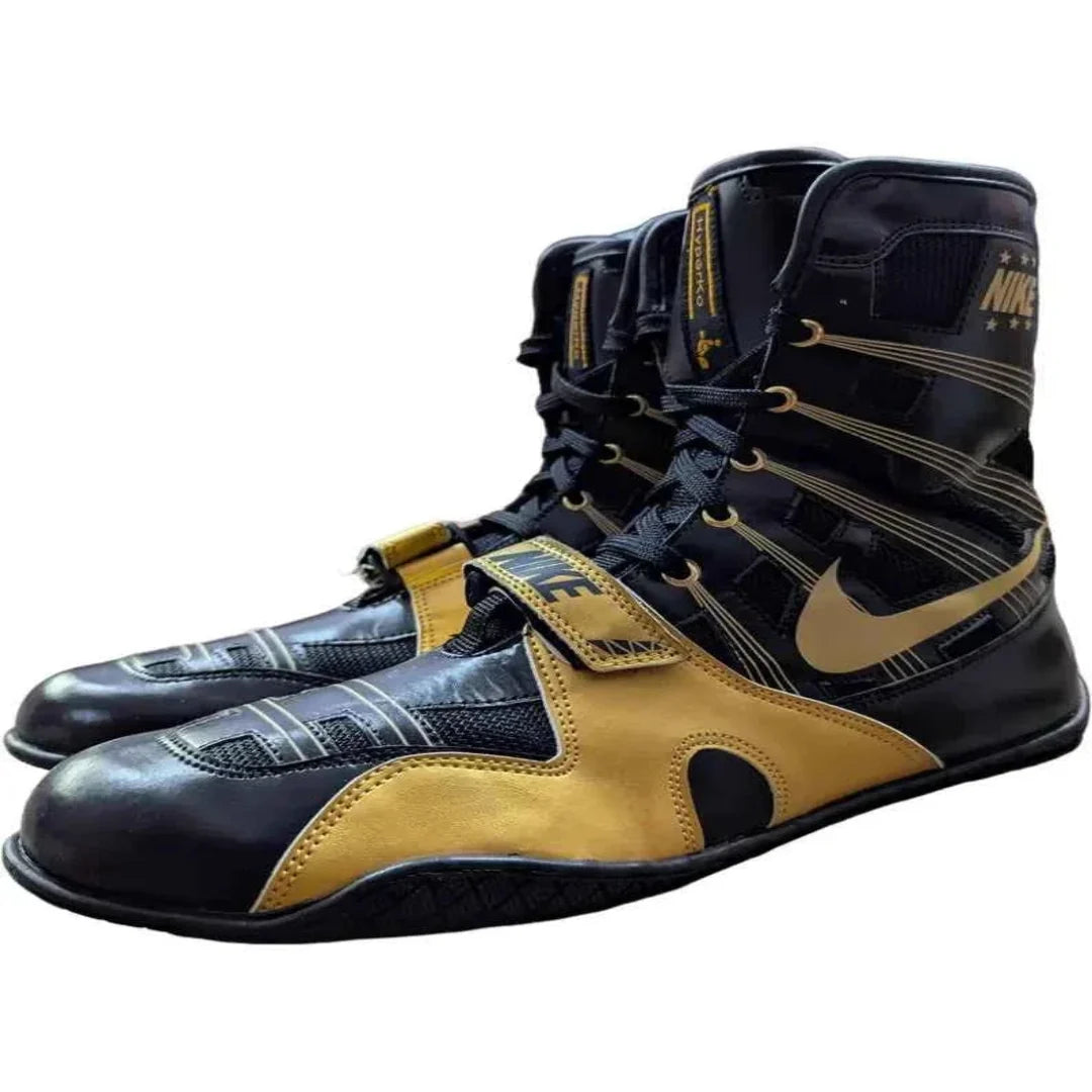Black and gold boxing shoes with Nike logo on a white background