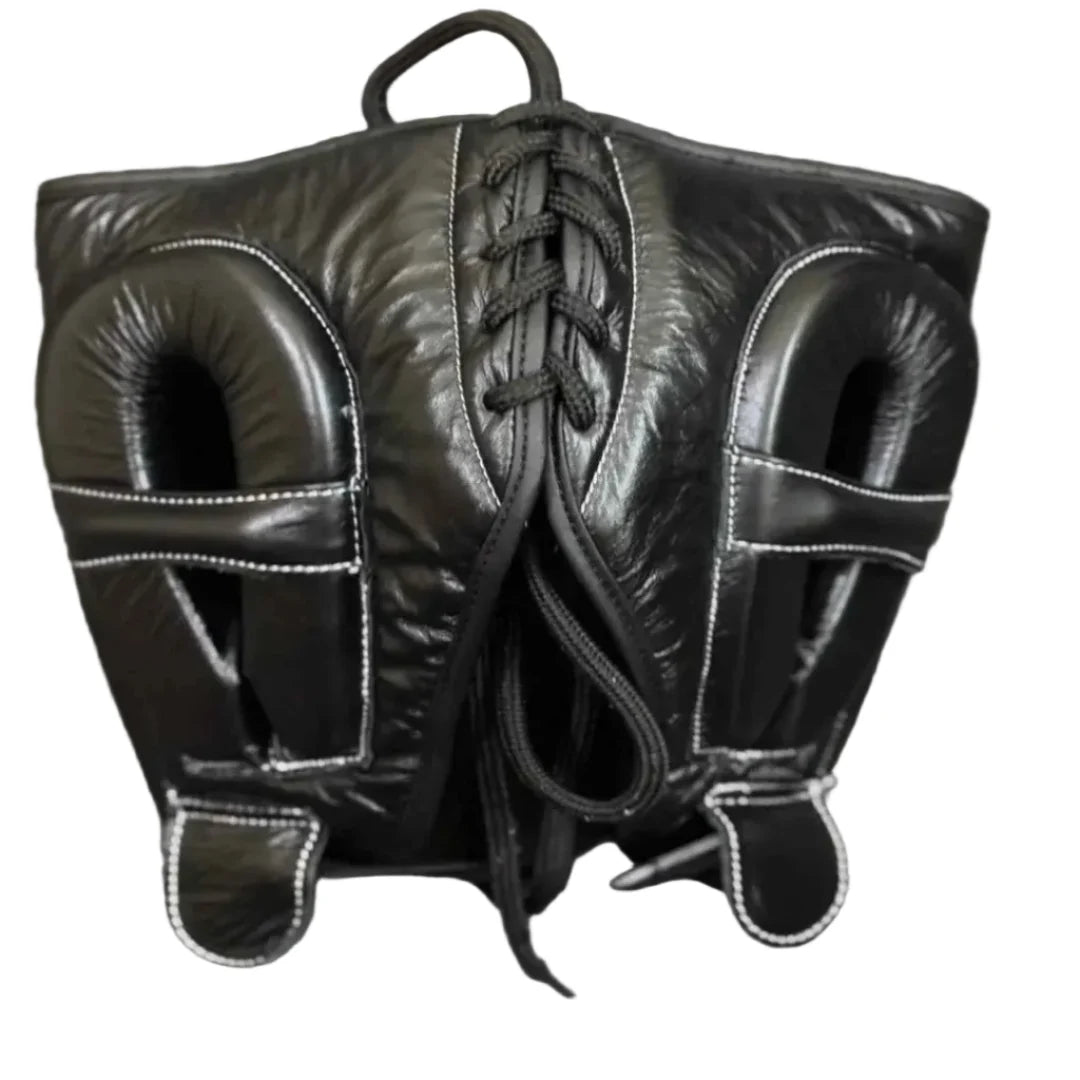 Pair of black leather boxing mitts on a gray surface