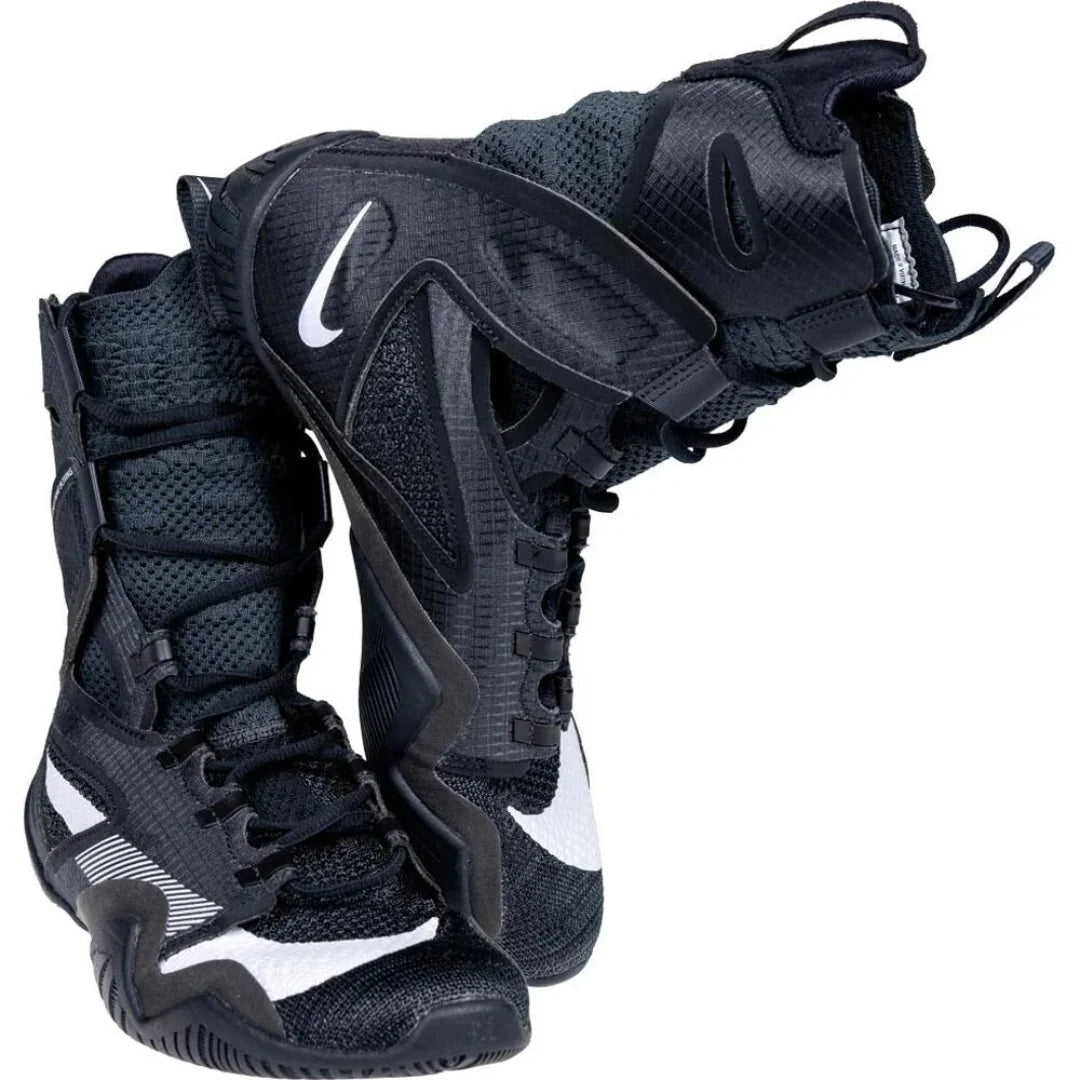 A pair of black Nike athletic sneakers with white swoosh logos, shown against a plain white background.