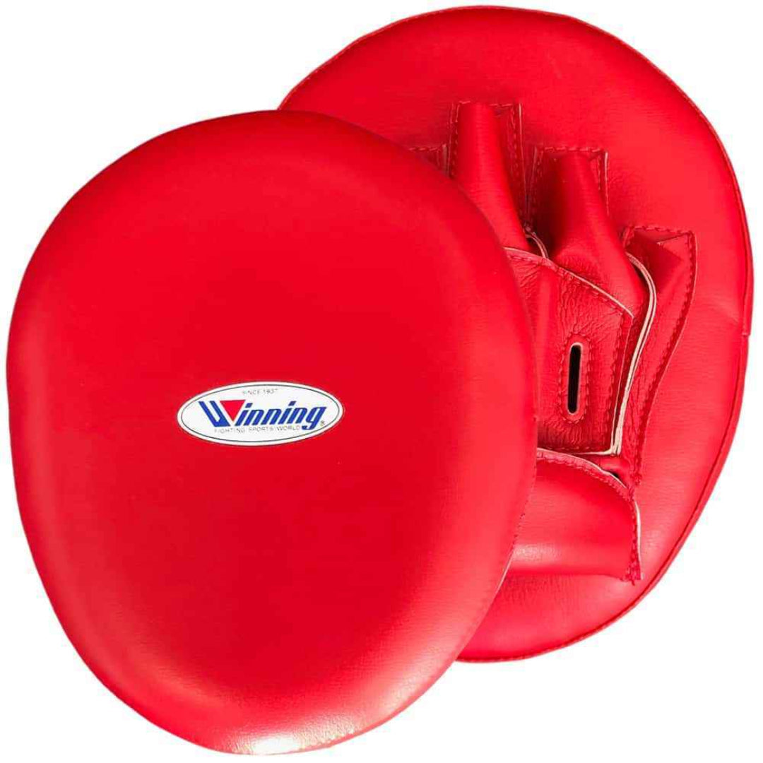 Red boxing mitts with a visible brand logo on a white background